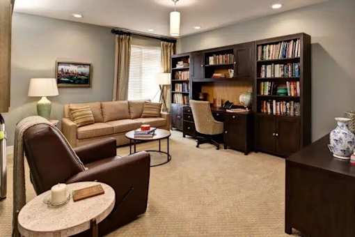 A living room with a library and a couch at The Piper, Kansas City, KS. 
