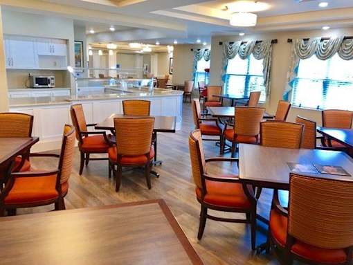 A dining room with wooden chairs and tables at Waterstone on Augusta, Greenville, SC
