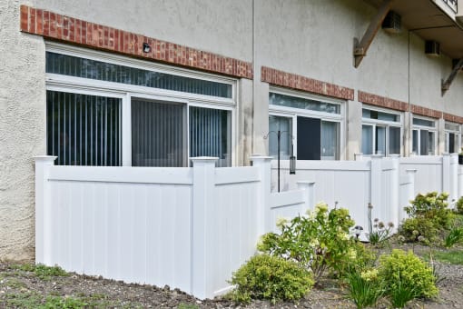 Private patio with white vinyl fence and landscaping at Fox Run Apartments, St. Charles, Illinois