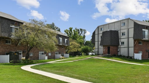 Apartment buildings with curved walkway and green lawn at Fox Run Apartments, Illinois