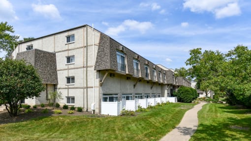 Apartment building exterior with private patios and landscaping at Fox Run Apartments, St. Charles, IL 60174