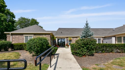 a house with a walkway and a black railing in front of it at Aspen Ridge Apartments, West Chicago, Illinois