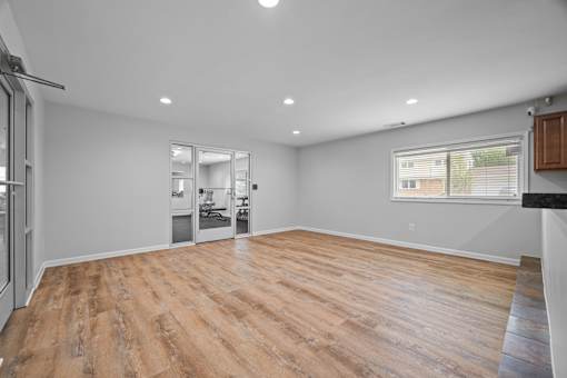 Empty room with wood flooring and glass doors at Fox Run Apartments, Illinois