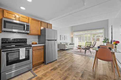 Open concept kitchen and living room with wood flooring at Fox Run Apartments, St. Charles, 60174