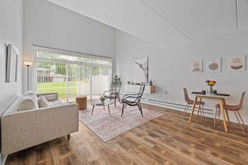 Living room with dining area and vaulted ceiling at Fox Run Apartments, St. Charles