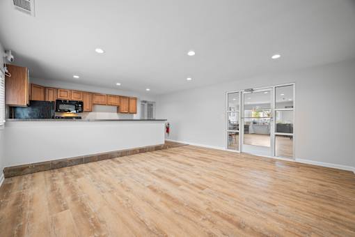 Open living space with kitchen and glass patio doors at Fox Run Apartments, Illinois