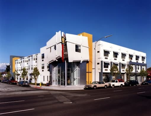 A white building with a yellow and red accent on the side.