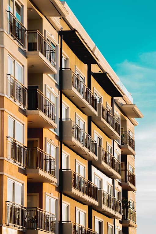 A tall building with balconies and windows.