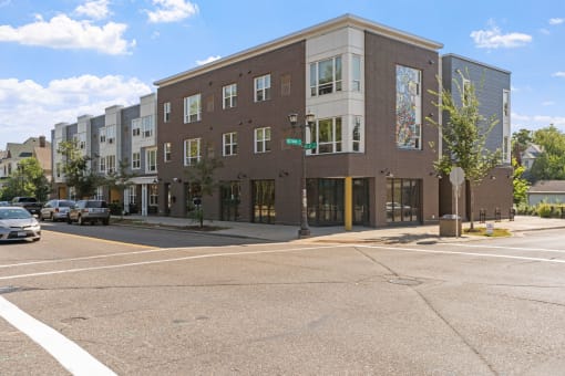 an apartment building on the corner of a city street