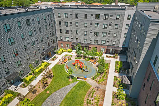 an aerial view of the courtyard of an apartment building with a playground
