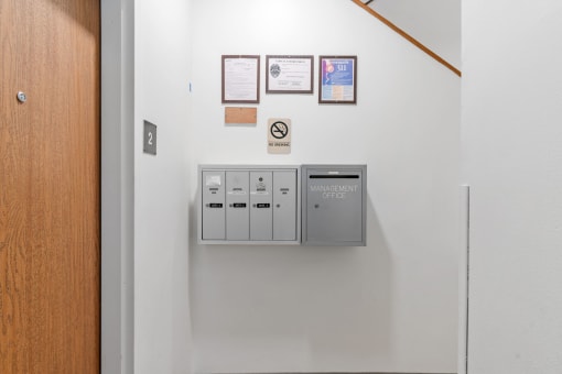 a control panel on a white wall in a hallway