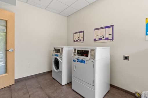 a laundry room with two machines and two washes in it