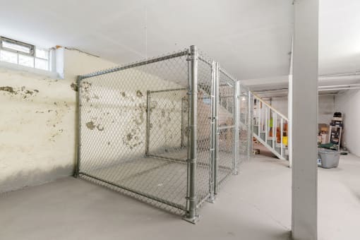 the interior of a building with a fenced in area and stairs