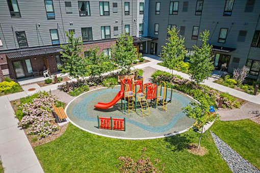 a playground in the middle of a park in a courtyard