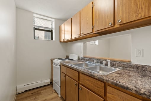 a kitchen with a sink and a stove and a window
