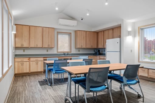 a dining room with a table and chairs and a kitchen