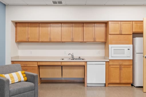 an empty kitchen with a microwave and a sink