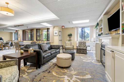 a living room with couches and chairs and a table