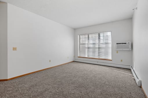 Photo of living room with large windows and wall mounted air conditioner