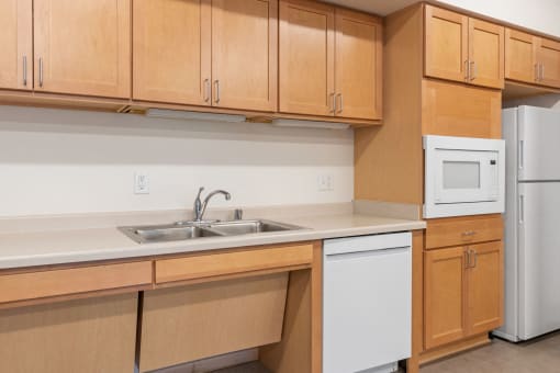 a kitchen with wooden cabinets and a sink and a refrigerator