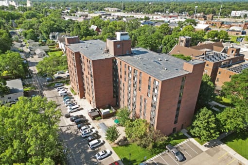 an aerial view of a brick building with a gray roof