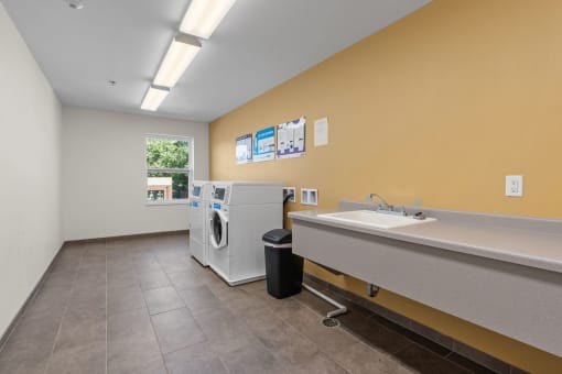 a laundry room with a sink and a washing machine in it