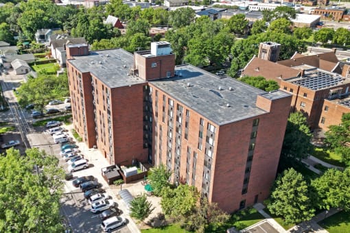 an aerial view of a brick building with a gray roof