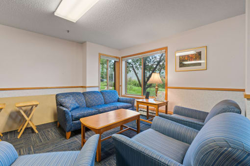 a living room with couches and chairs and a table