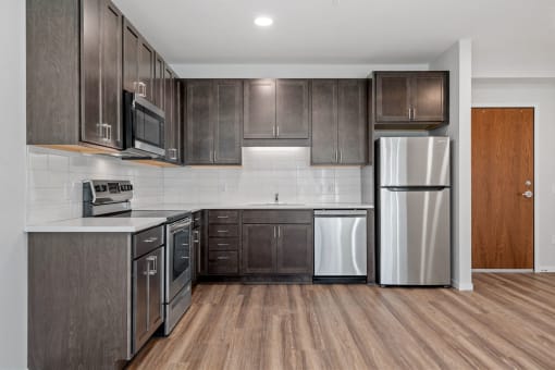 a kitchen with stainless steel appliances and wooden cabinets