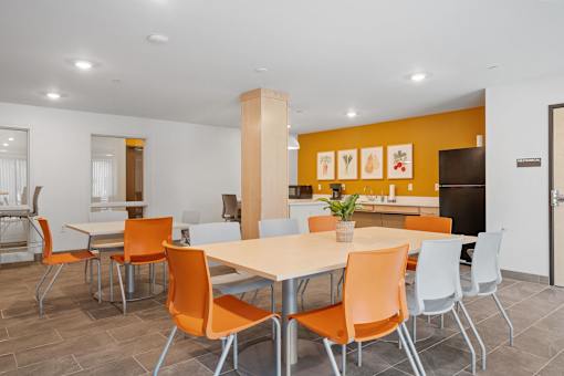 a dining room with orange chairs and a table