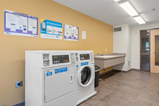 a laundry room with a washing machine and a sink