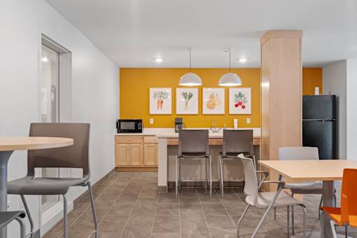a dining room and kitchen with a table and chairs