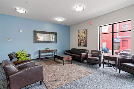a living room with leather furniture and a large window