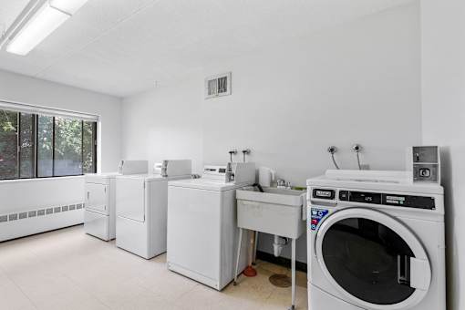an empty laundry room with washing machines and other appliances