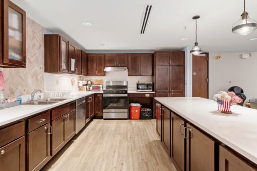 a large kitchen with wooden cabinets and white counter tops