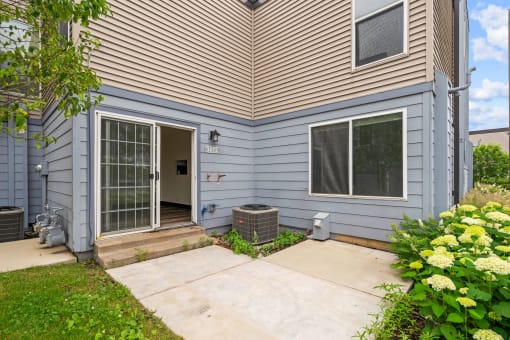 the back of a house with a patio and a backdoor