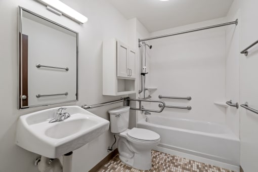 a bathroom with a sink toilet and a bath tub