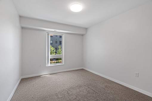 a room with white walls and a window