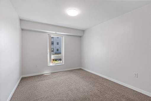 a room with white walls and a window
