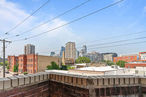 the view of the city from the roof of a building