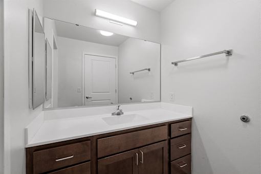 an empty bathroom with a sink and a mirror