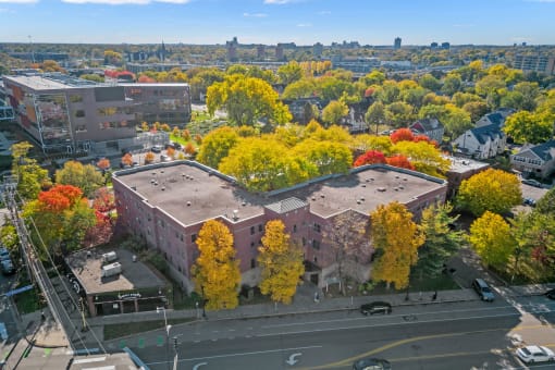 an aerial view of a building in a city with trees