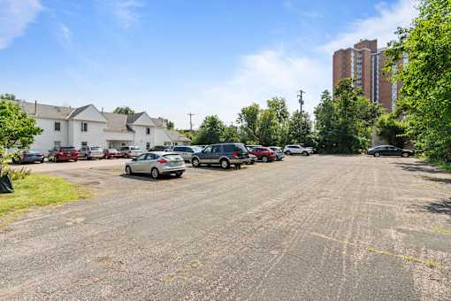 a parking lot with cars parked in front of a building
