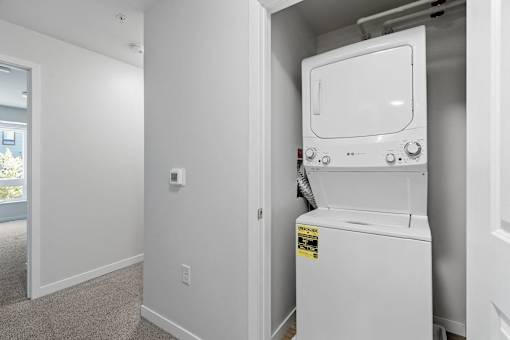 a white washer and dryer in a room next to a door