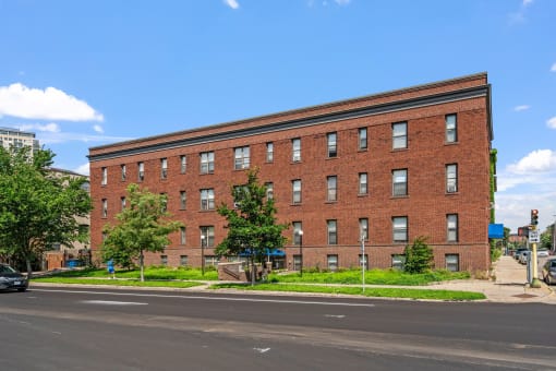 a plane is flying in front of a brick building