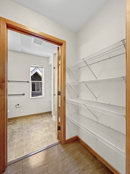 an empty room with an open door to an empty closet