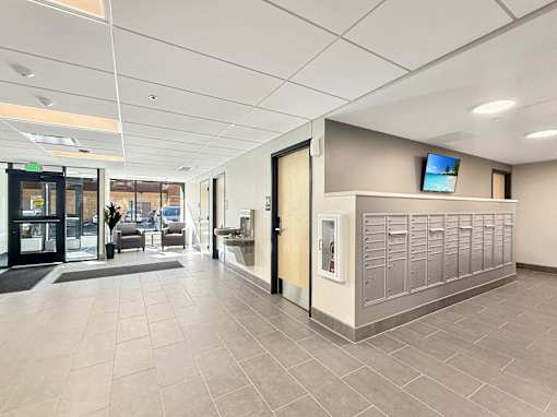A hallway with a lobby area and a reception desk.
