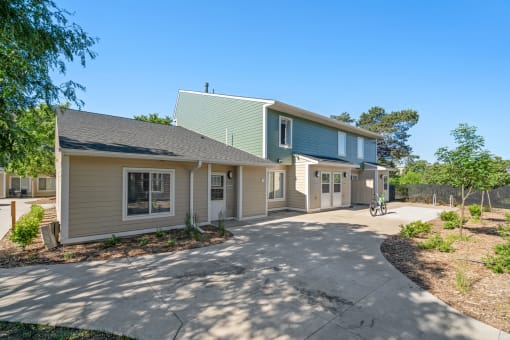 a house with a driveway and a bike parked outside of it