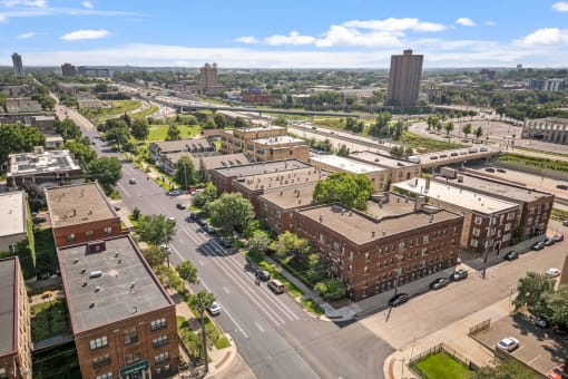 an aerial view of a city with buildings and cars on the street