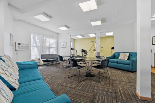 Party room with couches and chairs and a table